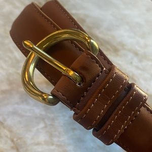 Tan Coach women’s leather belt with brass buckle.
